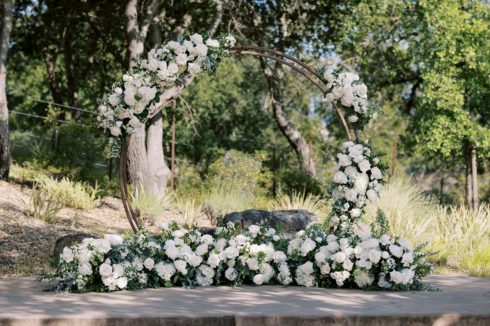 Circular arbor decorated with white florals.